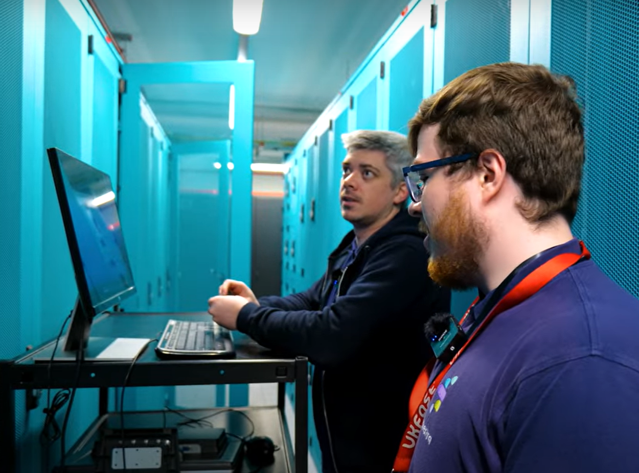 synextra employees in blue data centre installing new servers optimisng data centre security